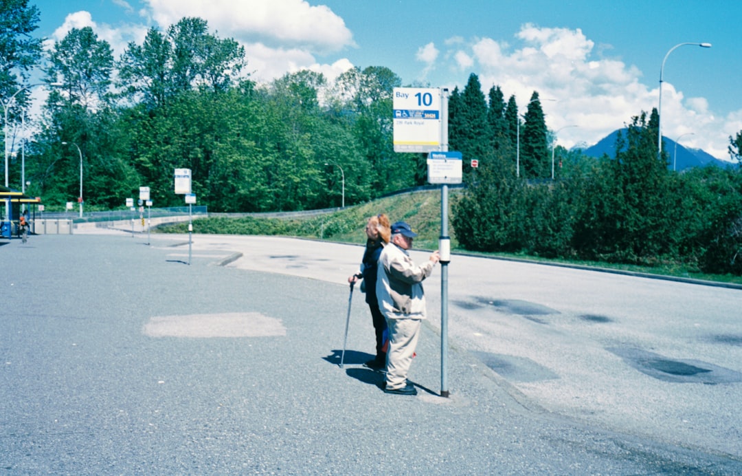 man in white shirt and black pants holding black stick