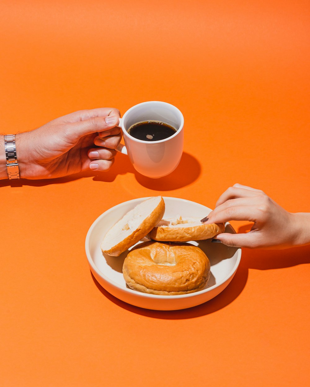 person holding white ceramic mug with brown liquid