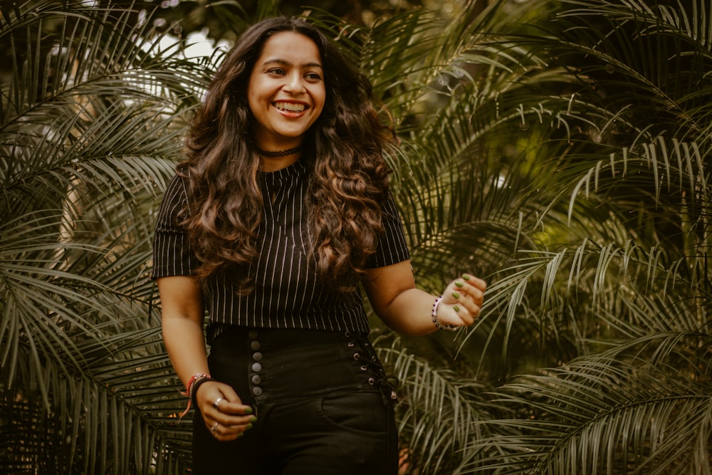 woman in black and brown stripe shirt smiling