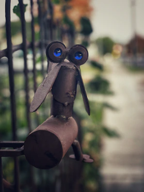 A whimsical metal garden sculpture shaped like a butterfly perched on a flower.