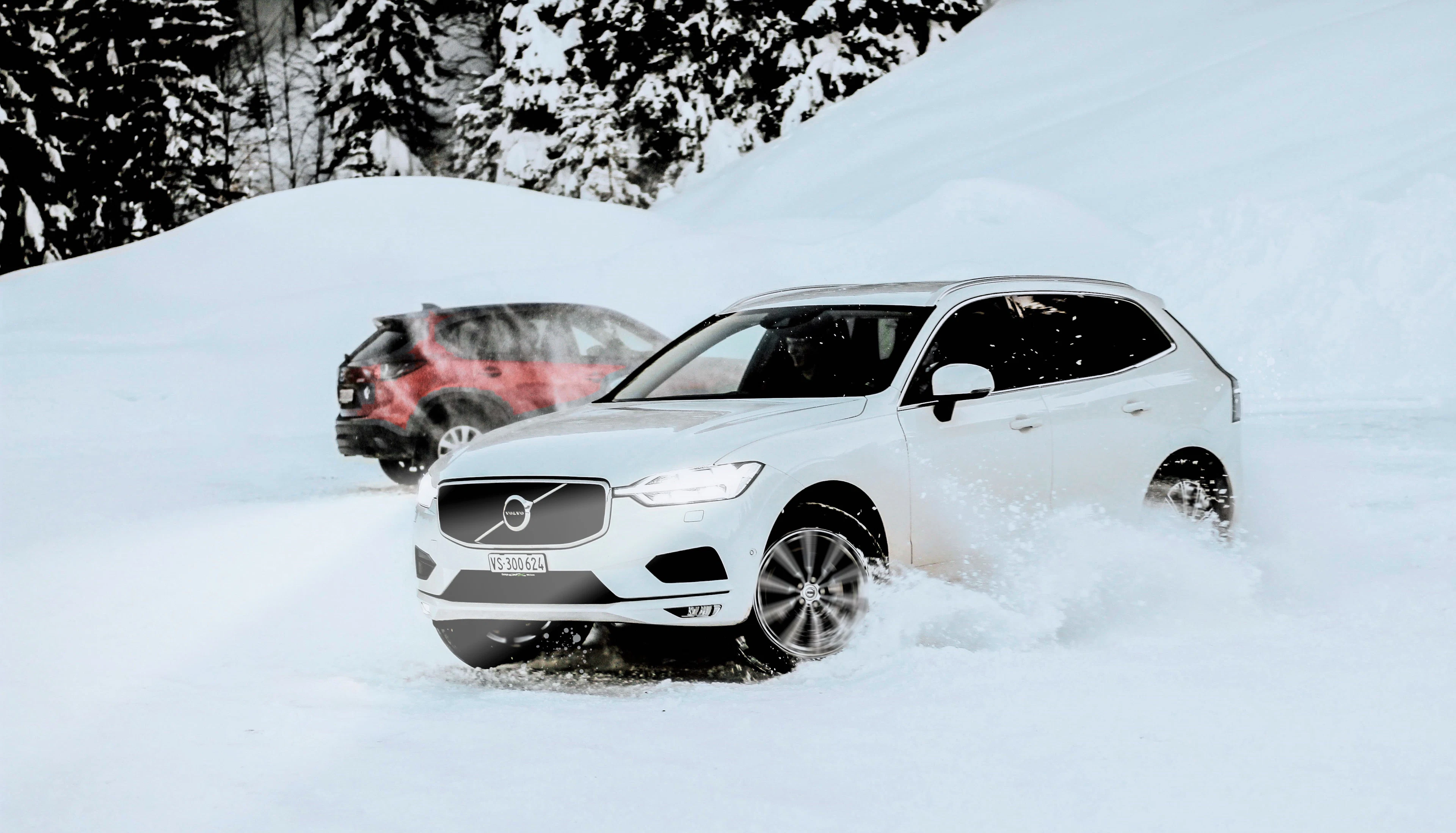White SUV driving through deep snow