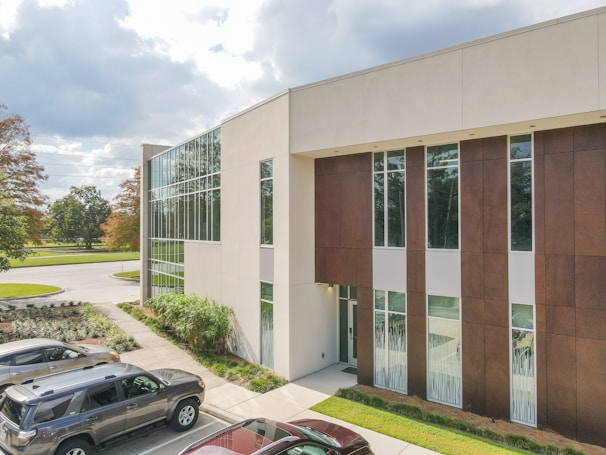 Wide shot of Novacure Pharma’s research facility exterior with clean lines and a calm blue sky.