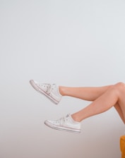 woman in white low top sneakers