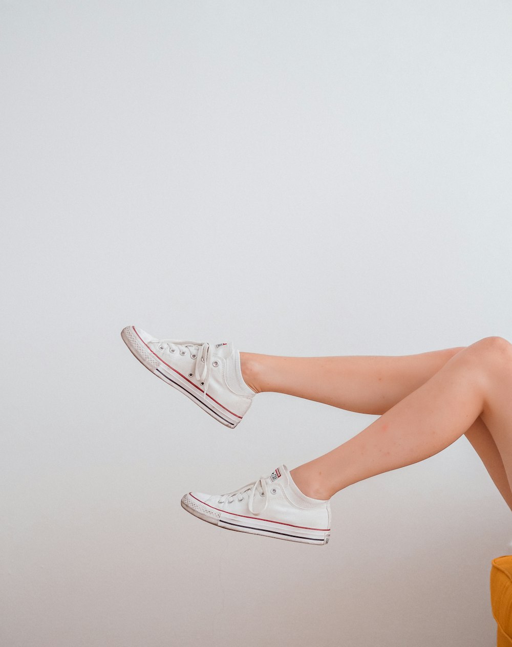 woman in white low top sneakers