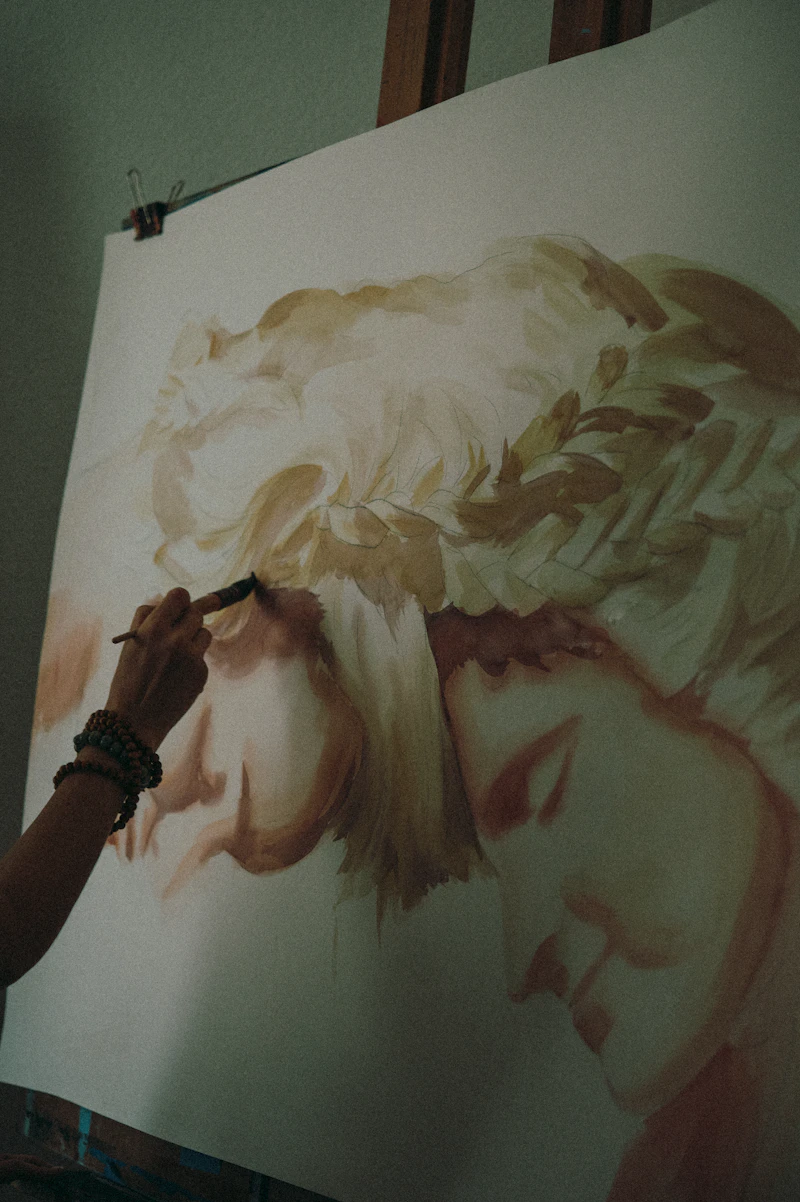 A contemporary portrait artist at work in their studio