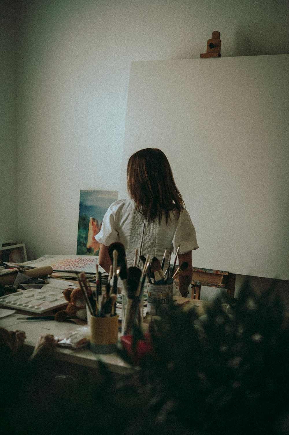 woman in white t-shirt painting