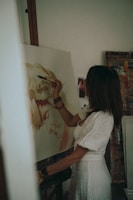 woman in white shirt painting