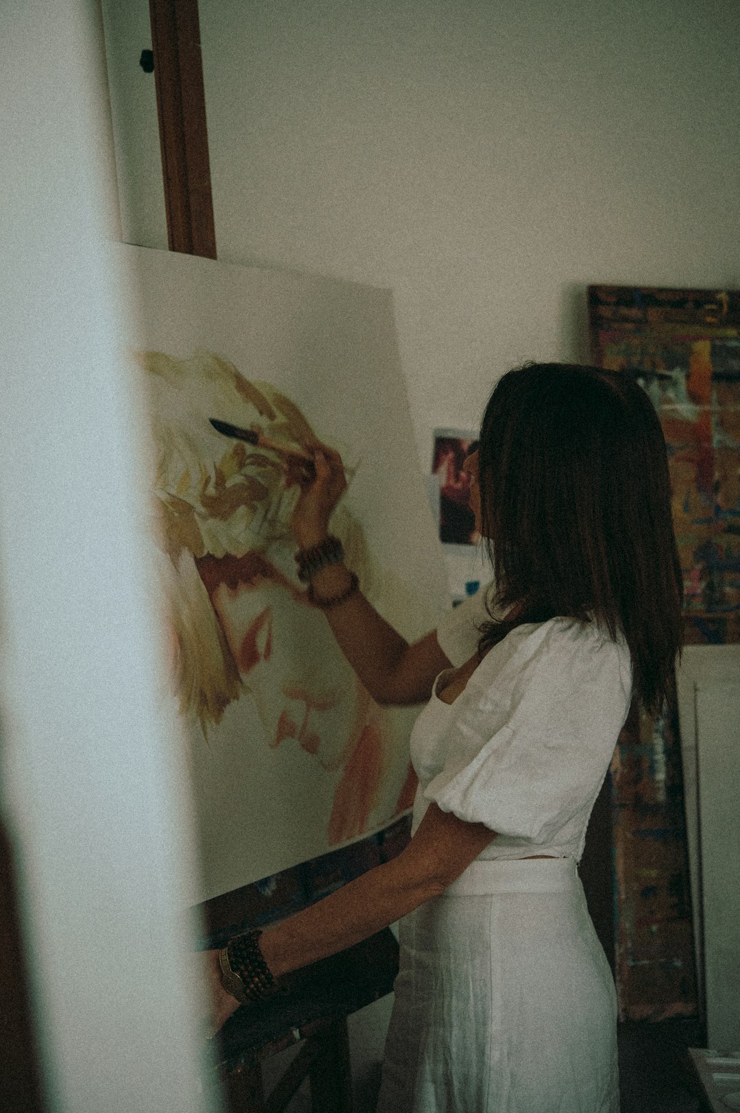 woman in white shirt painting