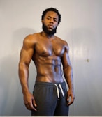 topless man in black pants