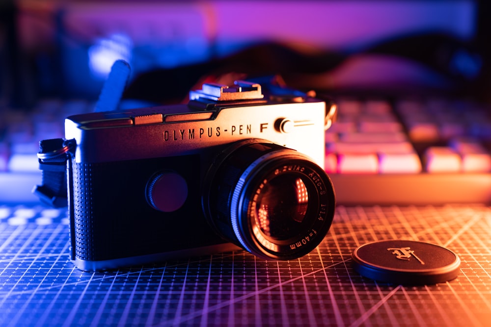 black and silver camera on blue table