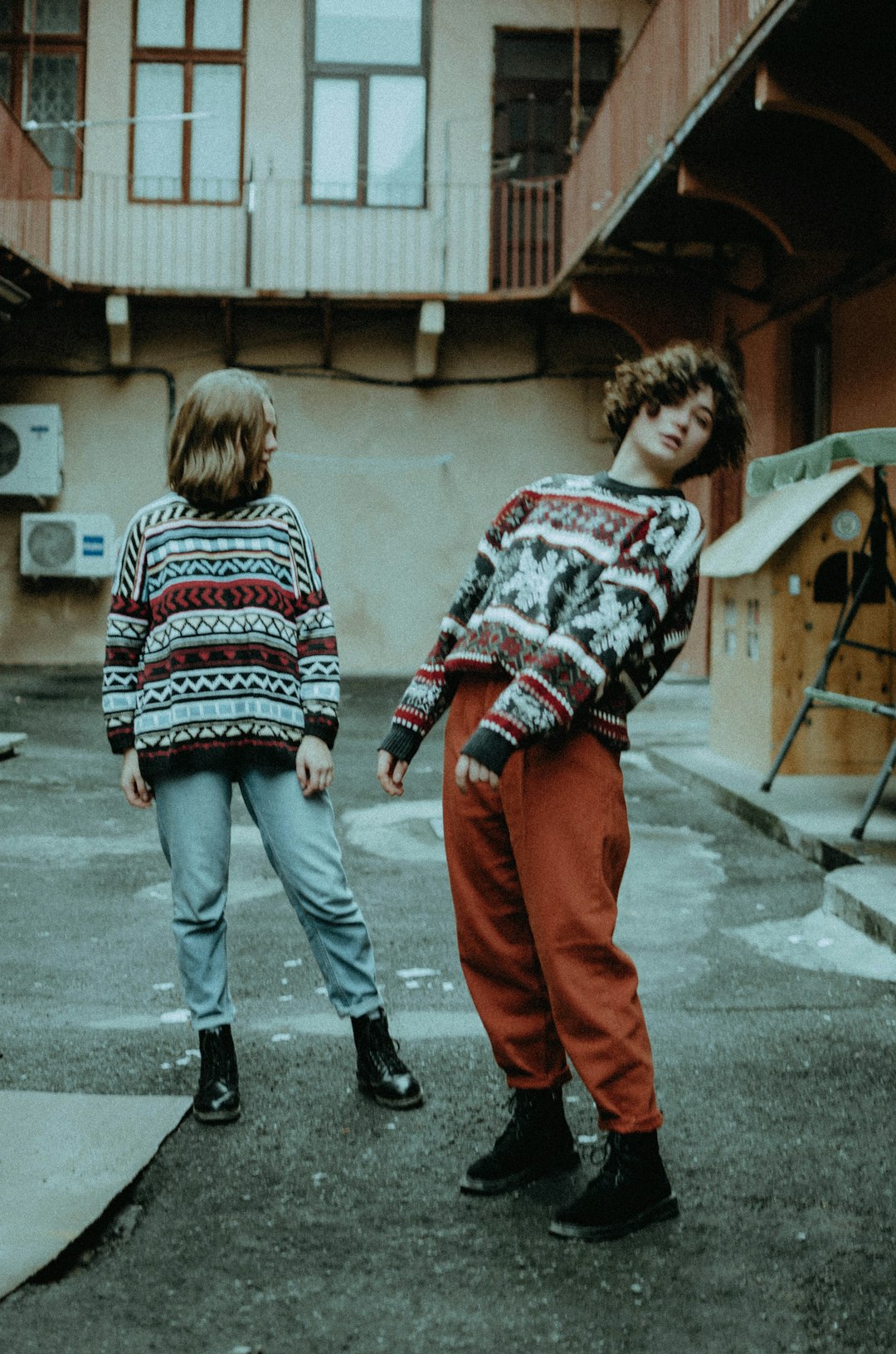 2 boys walking on sidewalk during daytime