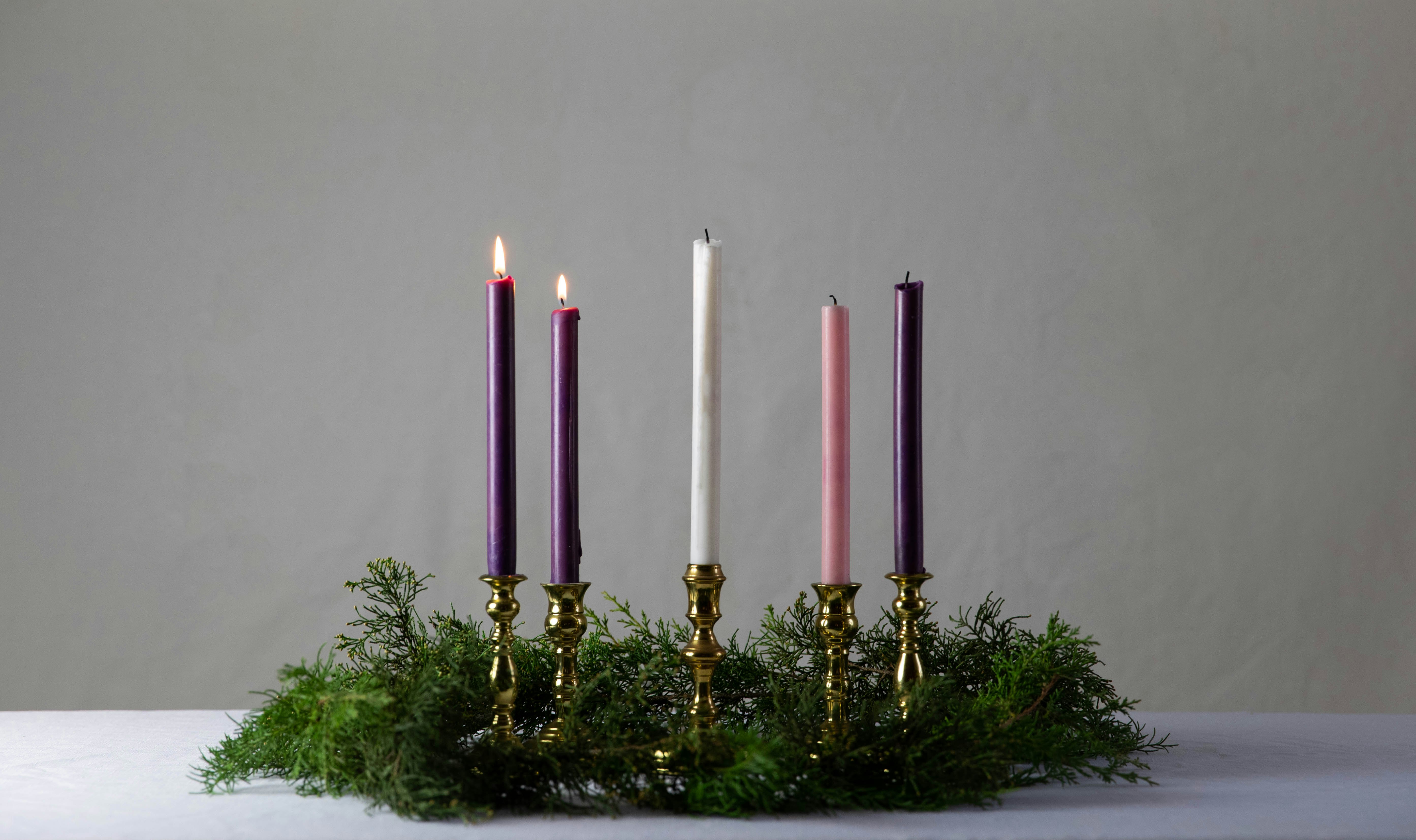 white candles on gold candle holder