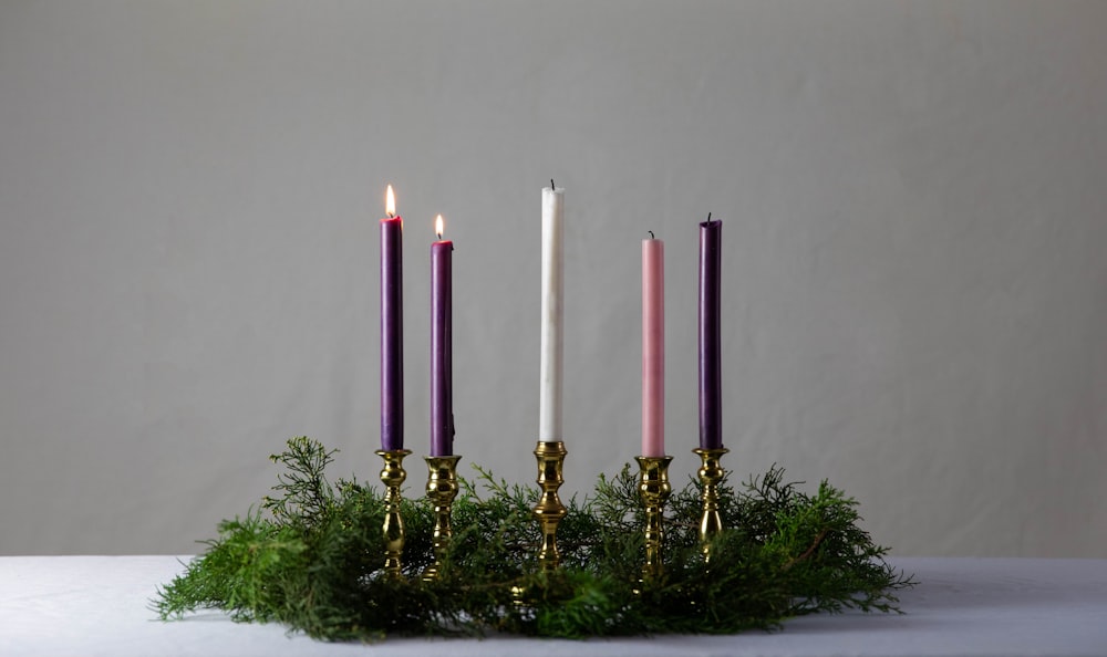 white candles on gold candle holder