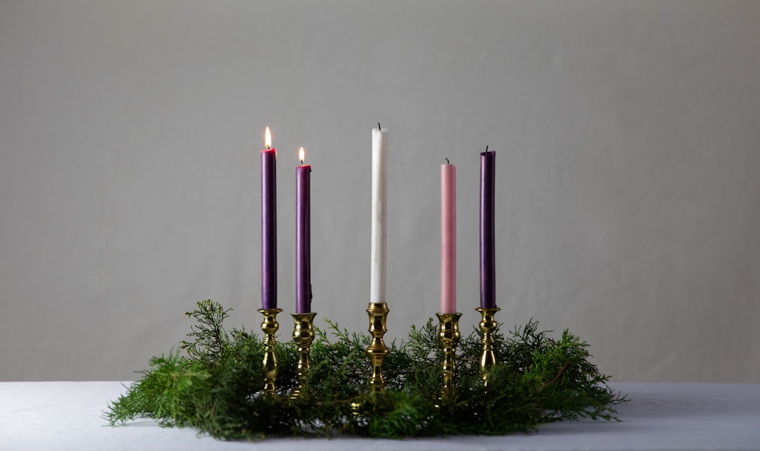 white candles on gold candle holder,