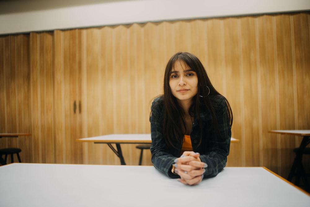 woman in black leather jacket sitting on chair