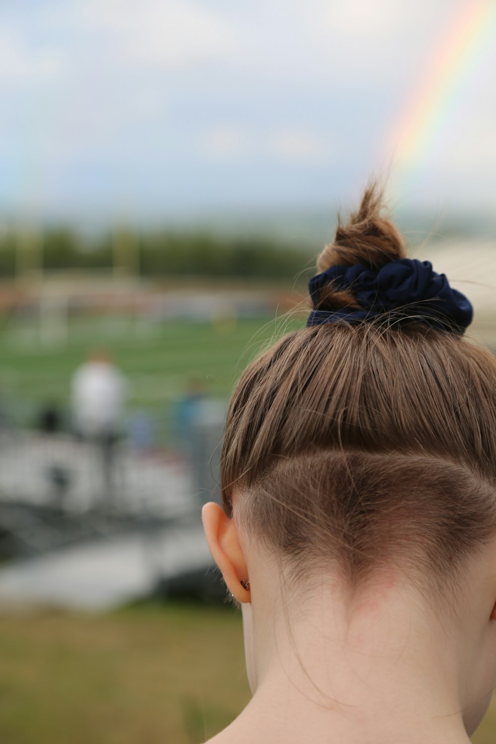 woman in black hair tie looking at the sky during daytime