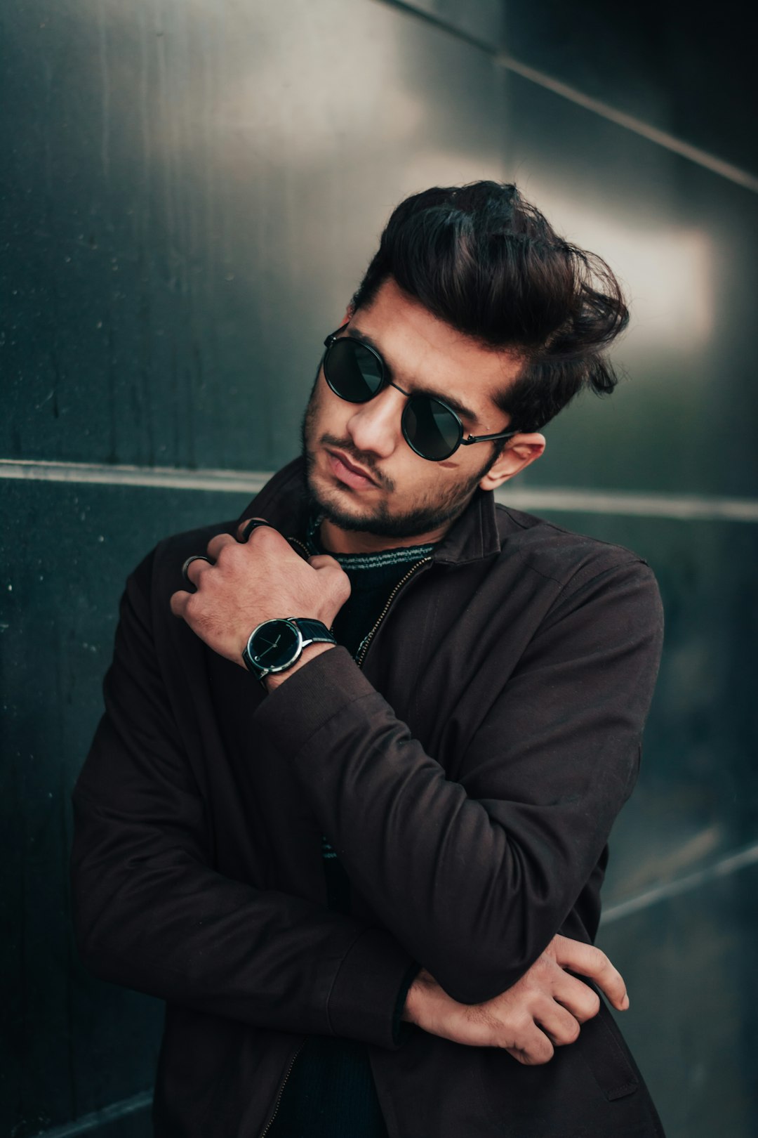 man in brown long sleeve shirt wearing black sunglasses