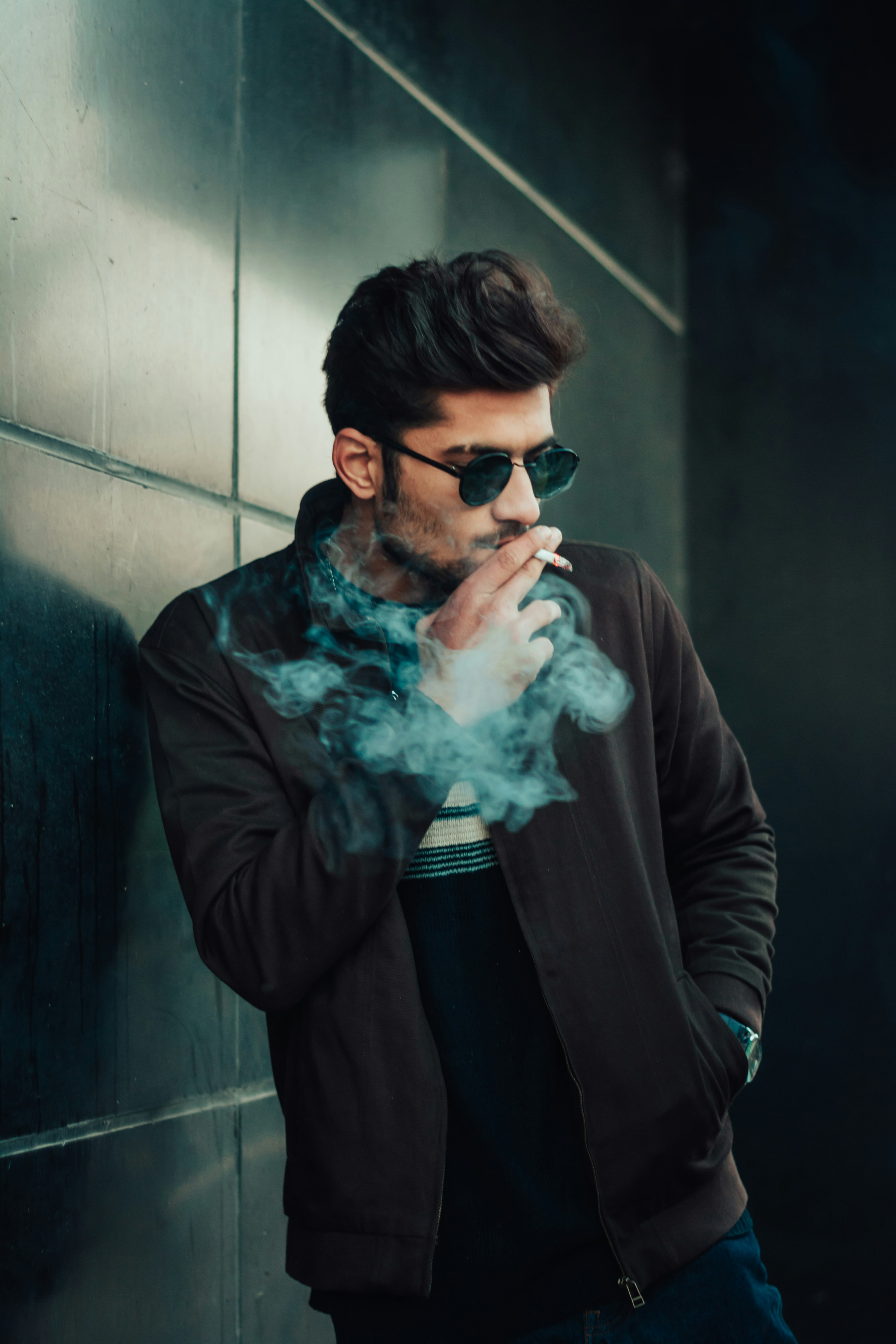 man in brown jacket smoking