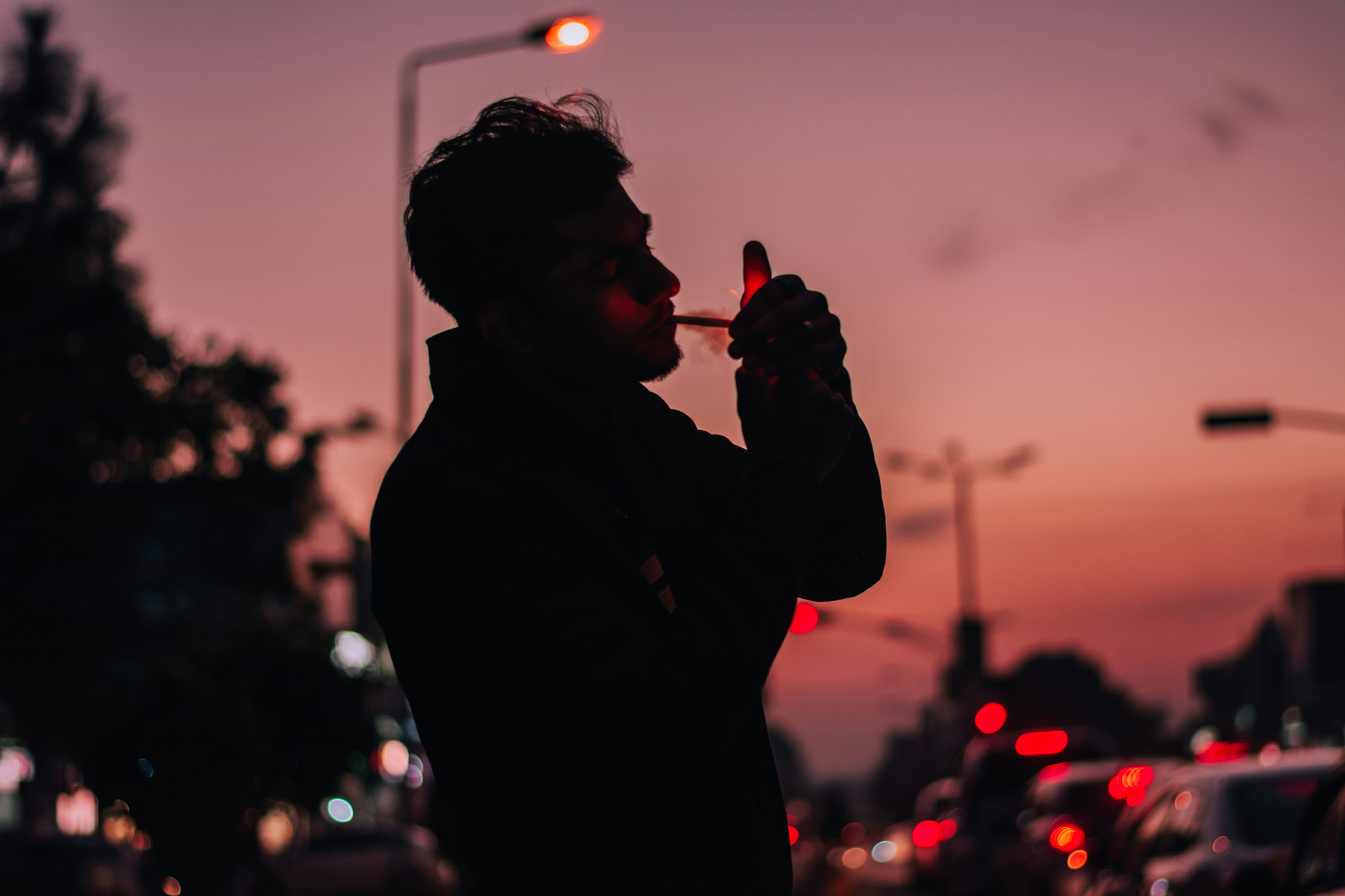 silhouette of man holding red light