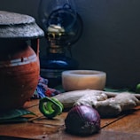 Rustic kitchen setting with traditional Nepali pottery holding colorful pickles.