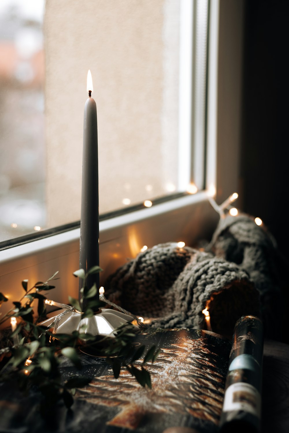 white candle stick on brown wooden table