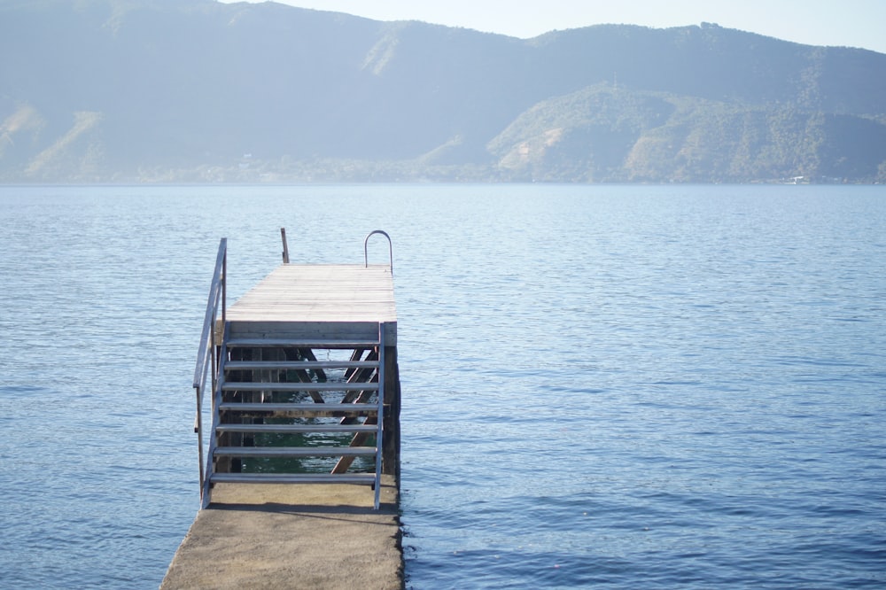 brown wooden dock on sea during daytime