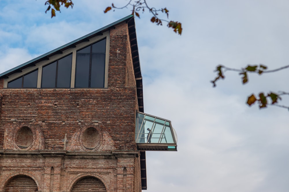 brown brick building under white clouds during daytime