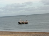 A scenic view of a boat on the calm sea.