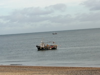A scenic view of a boat on the calm sea.
