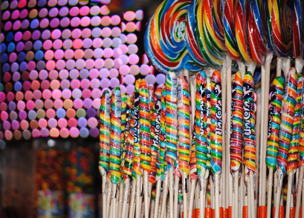 multi colored round lollipop on white paper