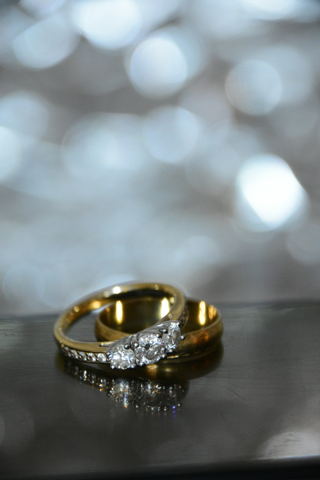 gold ring on black wooden table