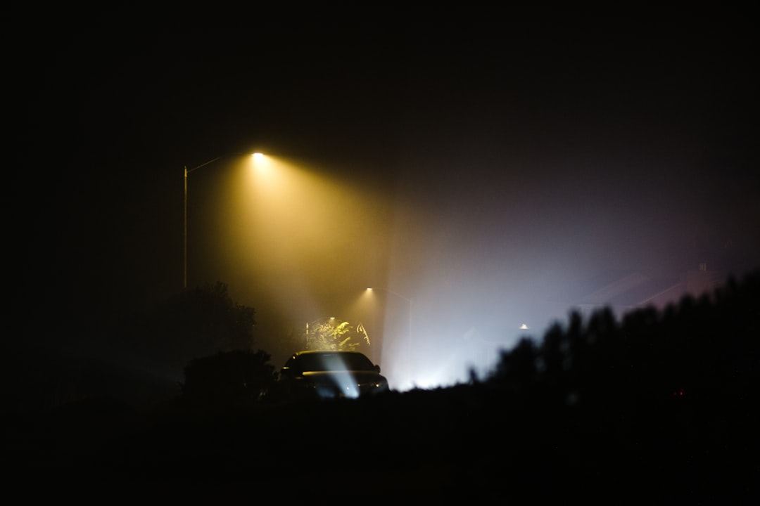 silhouette of car on road during night time