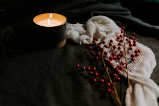 white candle on black holder