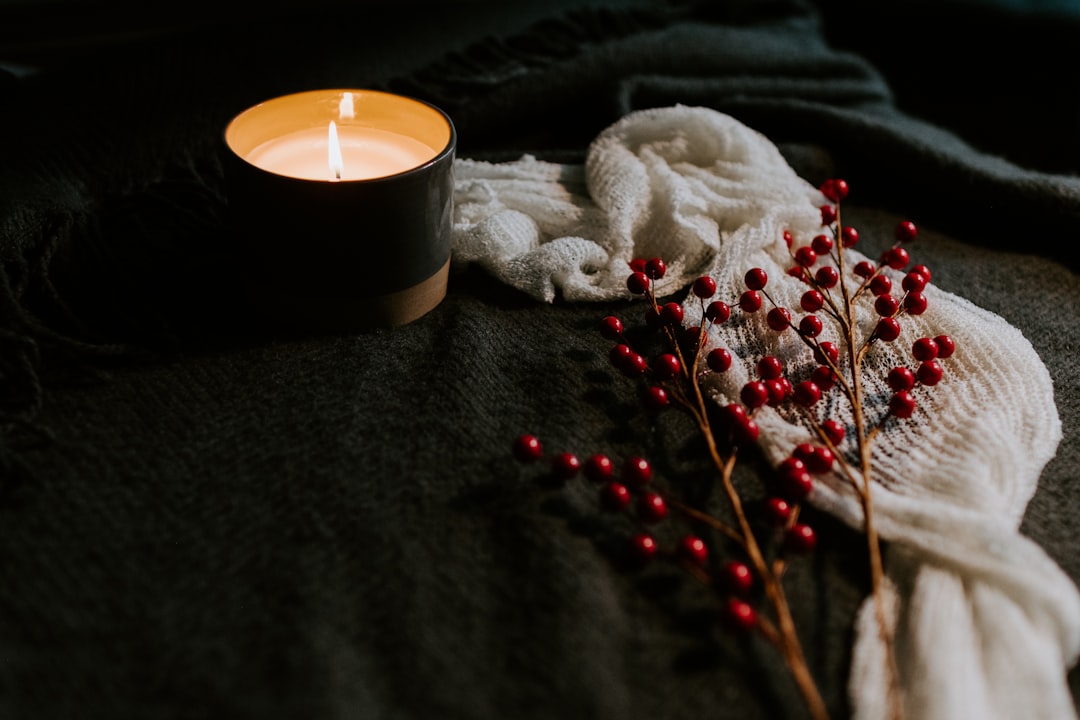 white candle on black holder, Berries and a candle on a table