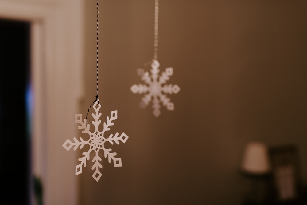 white snowflake hanging decor on brown wall