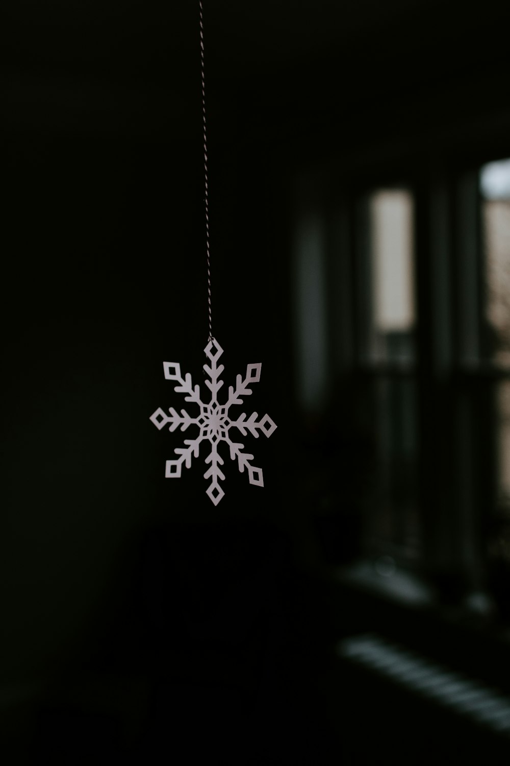 silver star pendant necklace in dark room