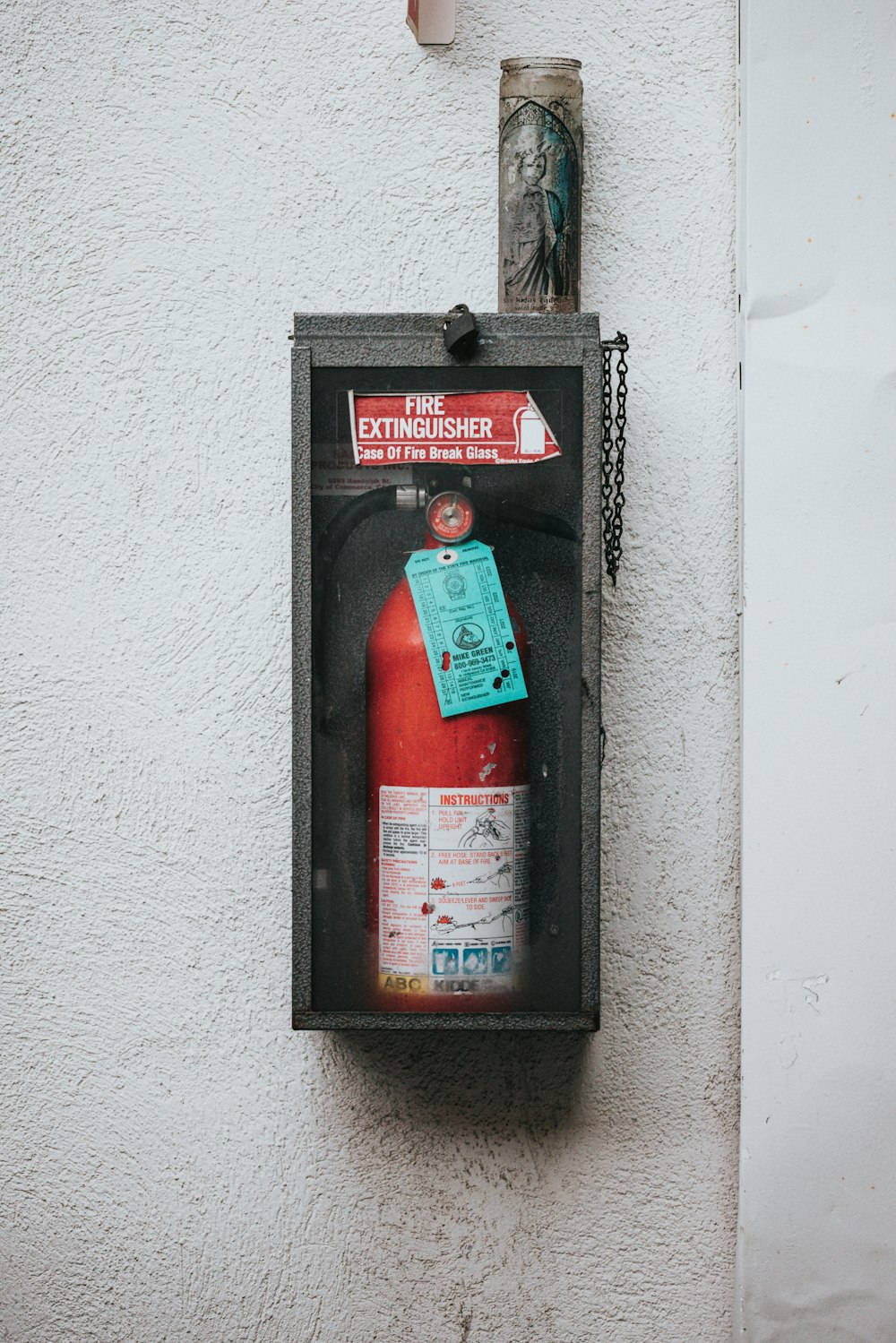 red fire extinguisher on wall