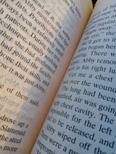 An open book with visible printed text on its pages. The pages are slightly tilted, with clear, readable words in a typical serif font. The text appears to be in English and discusses topics related to medical procedures or situations.