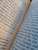 An open book with visible printed text on its pages. The pages are slightly tilted, with clear, readable words in a typical serif font. The text appears to be in English and discusses topics related to medical procedures or situations.