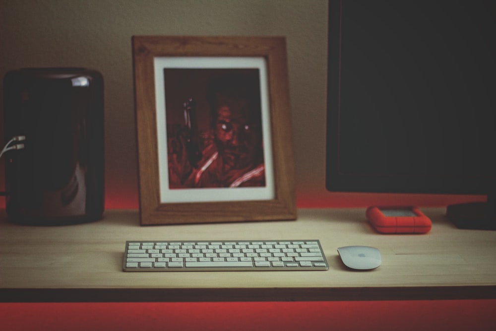 white computer keyboard beside white computer monitor