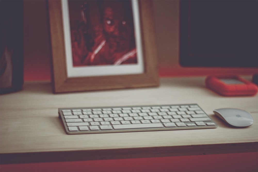 white computer keyboard on brown wooden table