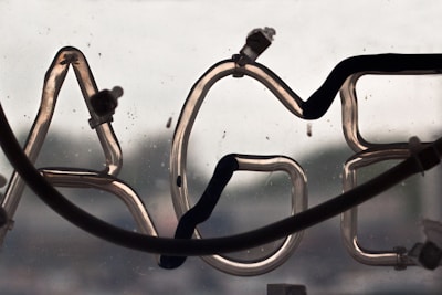 Close-up of a neon sign glowing with the words 'Adult Services' at night.