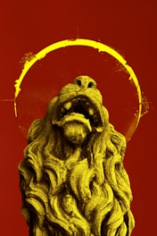 gray lion statue with red background