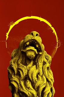 gray lion statue with red background