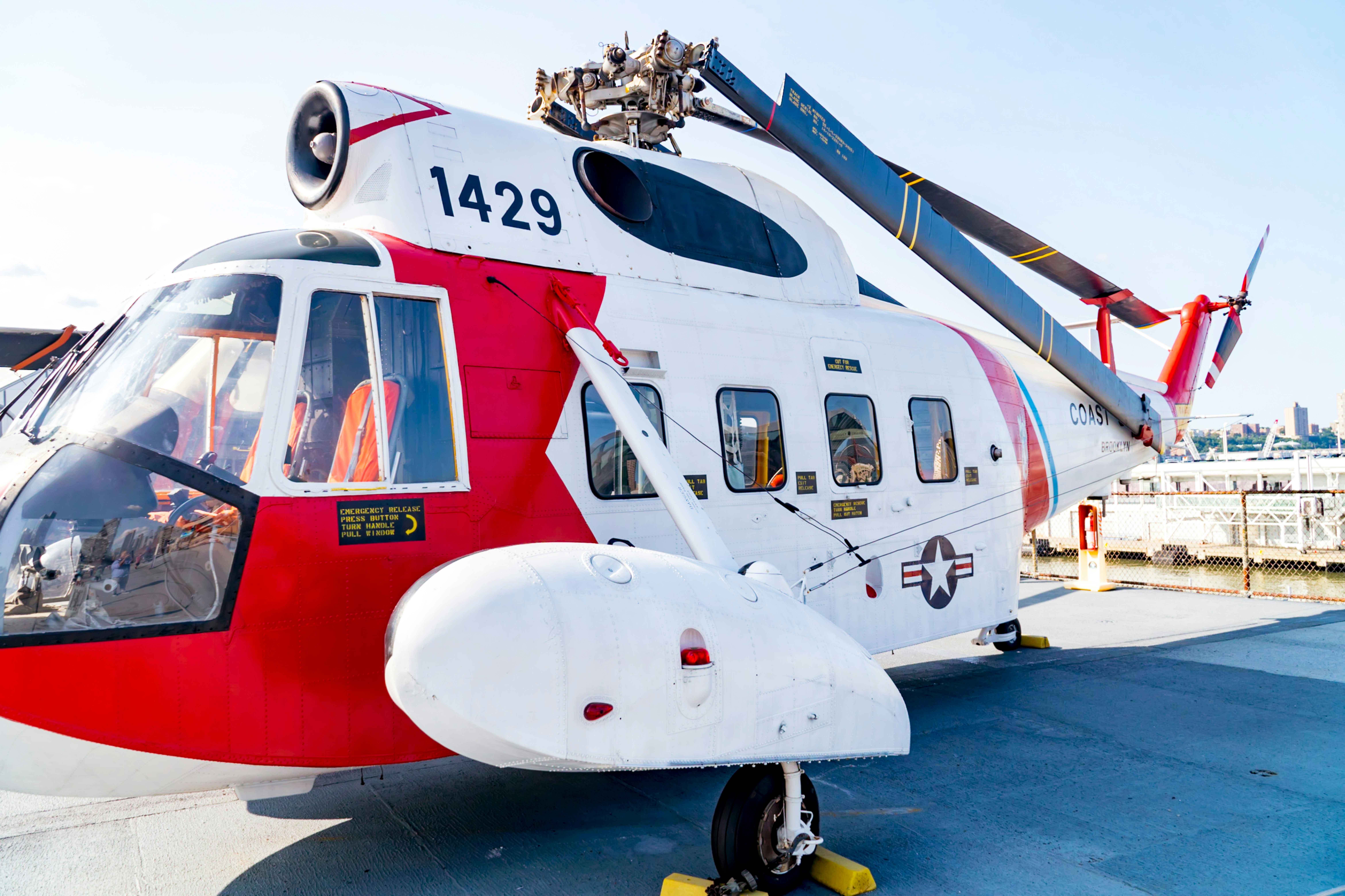 red and white helicopter on blue and white surface, U.S. Coast Guard helicopter 