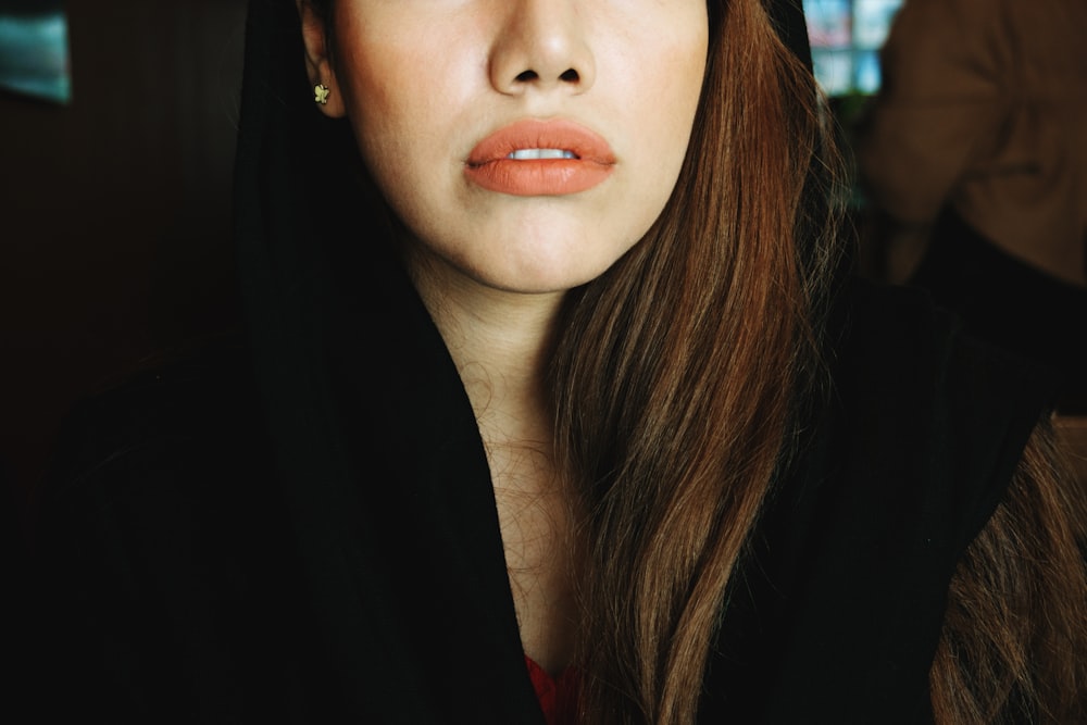 woman in black shirt with red lipstick