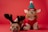 Two small dogs dressed in festive holiday costumes sit against a red background. The dog on the left wears a reindeer costume with antlers, while the dog on the right is dressed as an elf with a green hat and plaid trim, featuring elf-like ears.