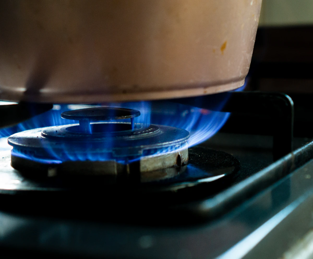 White plastic container on black gas stove