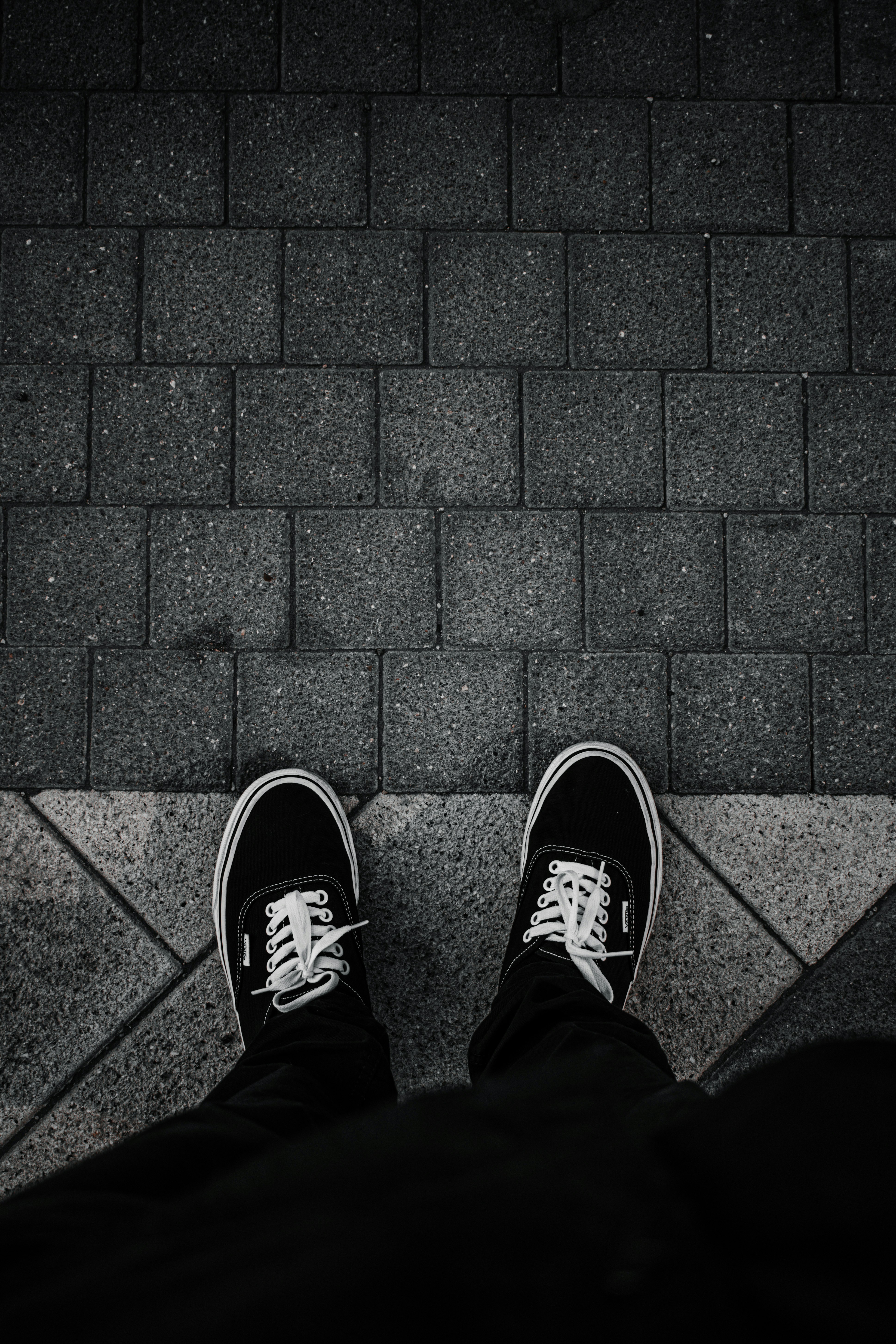person in black and white sneakers