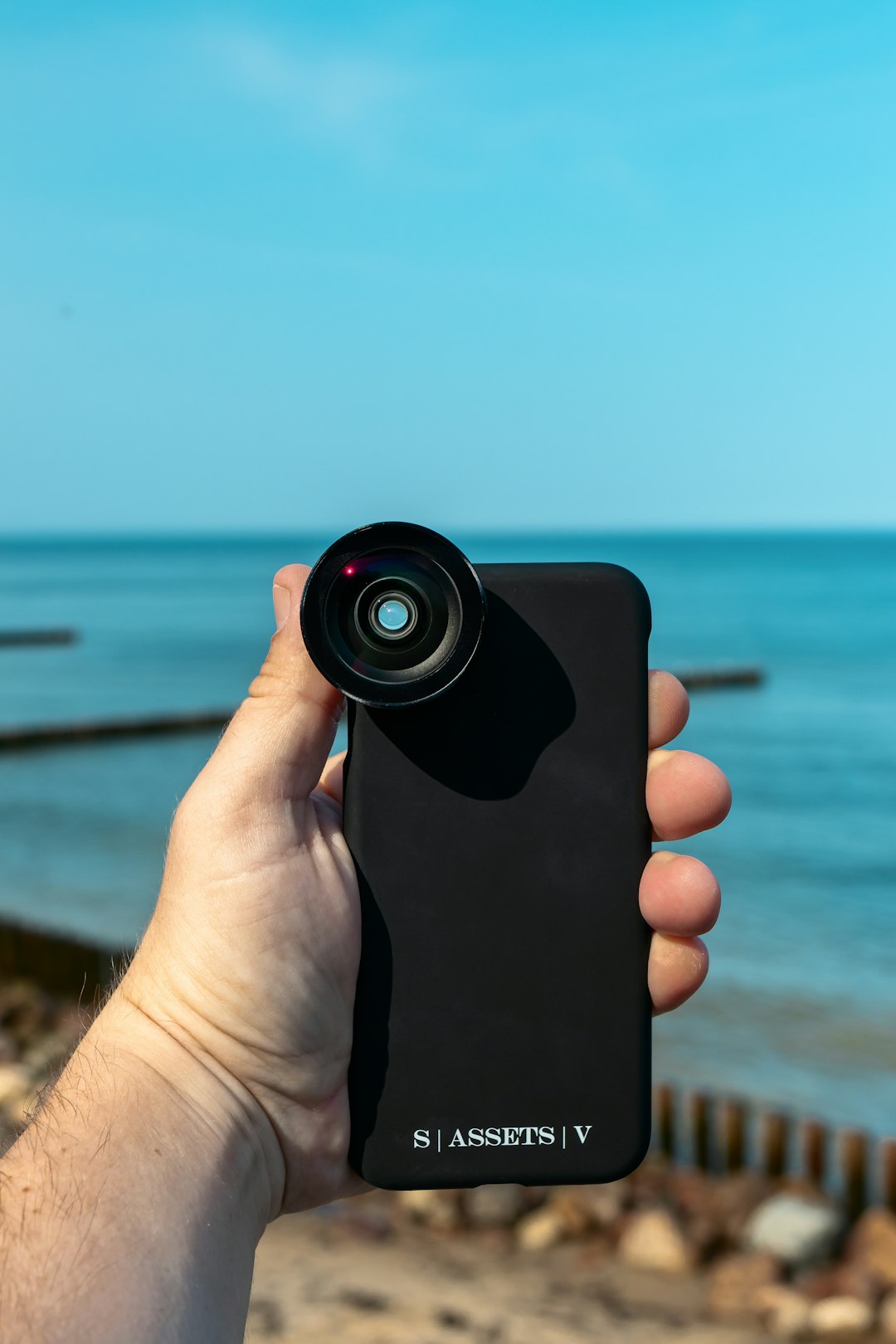 person holding black camera during daytime